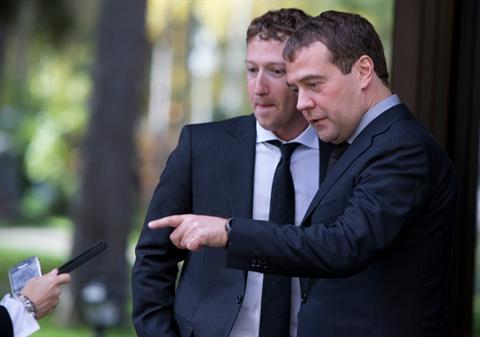 Russian Prime Minister Dmitry Medvedev, right, and Facebook CEO Mark Zuckerberg ask a Kremlin staffer to take a photo of them on their cell phones after the meeting at the Gorki residence outside Moscow, Russia, Monday, Oct. 1, 2012. (AP Photo/Alexander Zemlianichenko)